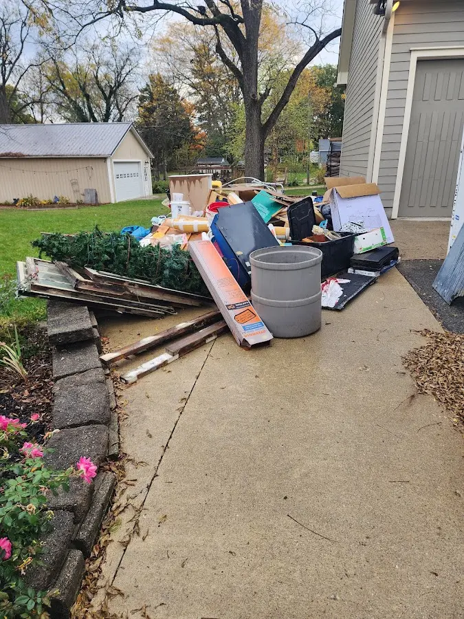 Dumpster being loaded with debris for 12 Yard Dumpster Rental in Lonoke